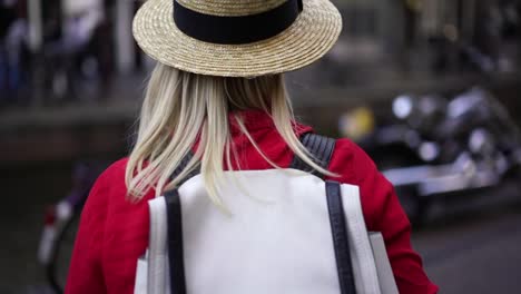 Authentic-Caucasian-woman-traveler-walking-on-street-in-city-using-app-on-mobile-phone-for-navigating