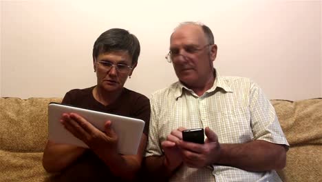 Attractive-adult-woman-and-adult-man-work-on-tablet-pc-and-smartphone.