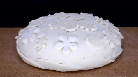 Pastry-time-lapse.-Yeast-dough-rising.-Decorated-dough.-Beautiful-easter-loaf-on-black-background.