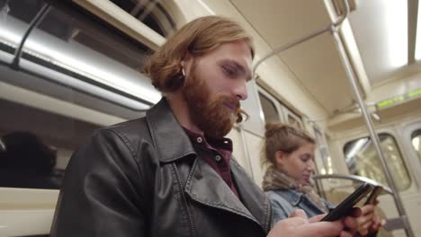 Passengers-Using-Phones-in-Subway-Car