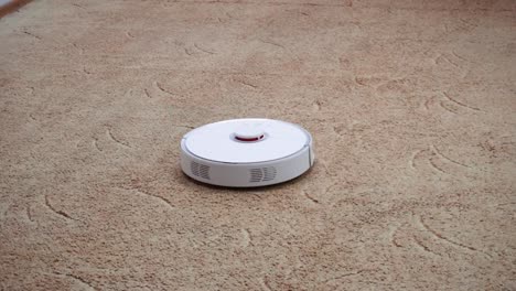 Close-up-shot.-Robotic-vacuum-cleaner-cleans-the-carpet-in-the-playroom