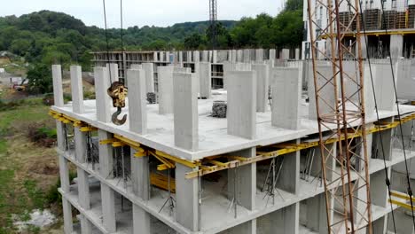 Flight-near-the-unfinished-monolithic-house.-Construction-crane-near-the-construction-site.-Top-view-of-the-construction