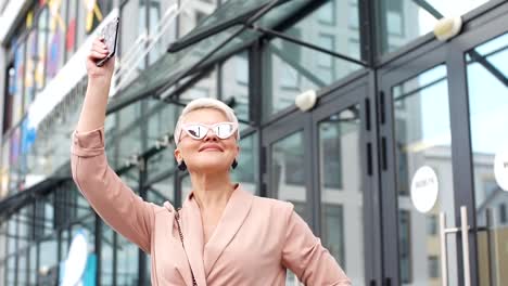 adult-Business-woman-with-tablet-pc-with-office-district-on-background