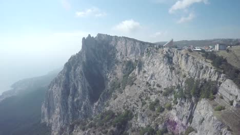 Aerial-view-of-the-movement-of-the-funicular-in-the-fog,-mountain-in-Crimea,-Ay-Petri.-Funicular-railway,-cable-railway,-cableway.