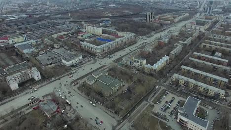 Aerial-survey-on-city.-View-from-the-sky-on-Russian-city.-Aerial-city-view-on-houses,-streets-and-parks.-Grey-sky-and-garages-really-residential-district.-Aerial-survey-on-the-street-where-drive-a-lot-of-car.Chelyabinsk.-Ural.-Overhead-Aerial-Flight-Over