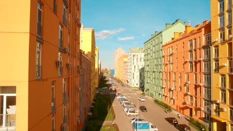 Flying-over-cozy-comfortable-colorful-buildings-in-a-European-city-4K-UHD-aerial