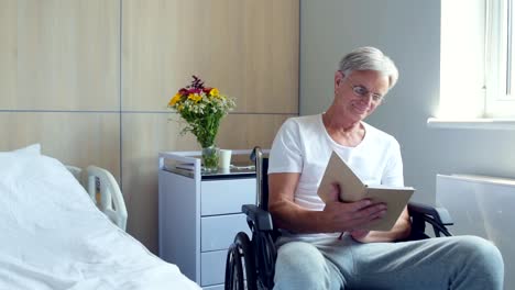 Nice-aged-man-reading-book-in-a-hospital-ward