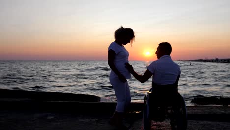 Couple-close-up-hugging-evening,-disabled-person-and-future-mother-looking-into-distance