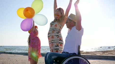 cheerful-mom,-daughter-with-balloons-and-dad-in-backlight,-little-girl,-mother-and-disabled-father