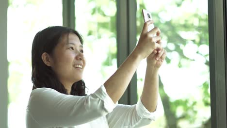 Asiatische-Frau-nehmen-Selfie.