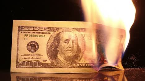 Dollar-bill-in-flames.-American-money-burning-on-black-background.