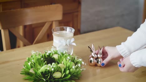 woman-arranges-beautiful-Easter-decorations-on-the-table