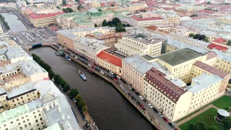 Panoramic-view-from-flying-drone-on-city-architecture-and-ship-floating-on-rive