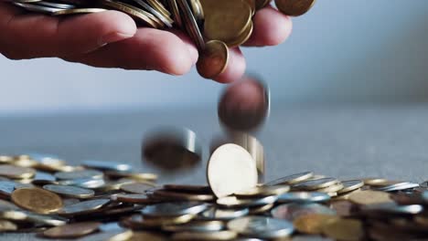 Businessman-holding-coins-in-his-palms.