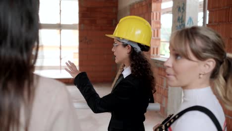 Woman-Talking-To-Lesbians-Buying-New-Home-In-Construction-Site