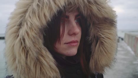 Closeup-portrait-of-a-young-beautiful-red-haired-woman-outdoors.-Girl-in-a-warm-fluffy-jacket