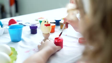 Little-Girl-Having-Fun-to-Paint-Easter-Eggs