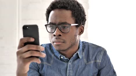 African-Man-Using-Smartphone,-Text-Messaging