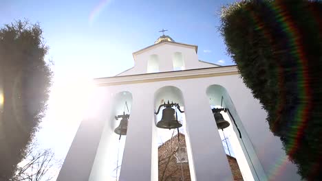 Church-bells-on-a-Sunny-day-in-a-strong-wind.-The-wind-shakes-the-trees-near-the-bell-tower-and-Sonechka-shines-in-the-cell-near-the-Church-bells