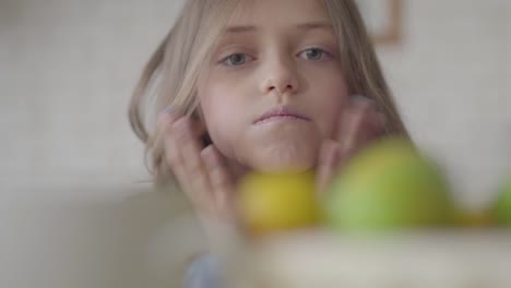 Portrait-of-cute-emotional-little-girl-making-faces-looking-in-camera.