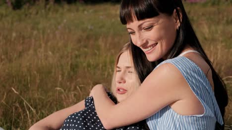 Two-young-attractive-women-hugging-at-sunset-in-nature.-Recreation-concept-outdoor.-Lesbian-couple