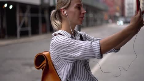 Slow-motion-effect-of-happy-Caucasian-woman-dressed-in-casual-wear-enjoying-online-conversation-via-smartphone-application