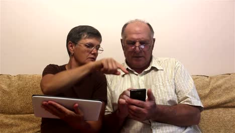 Attractive-adult-woman-and-adult-man-work-on-tablet-pc-and-smartphone.