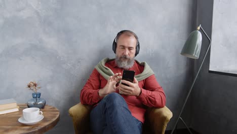 Aged-Man-Listening-to-Music-at-Home