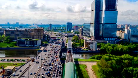 Dense-urban-car-traffic-and-ground-trains-arrive-on-the-platform-near-Moscow