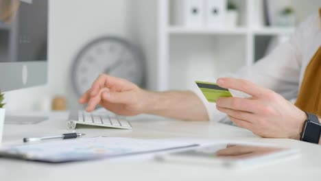 Hands-typing-credit-card-information-on-keyboard