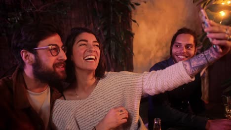 Caucasian-couple-taking-selfie-with-smartphone-during-friends-patio-party