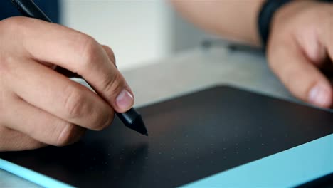 Close-Up-Of-Male-Hands-Using-Graphic-Tablet