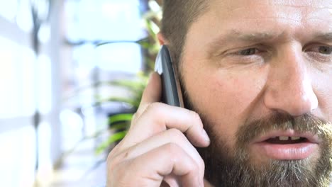 Close-up-on-businessman-face-talking-by-smartphone,-close-portrait,-steadicam