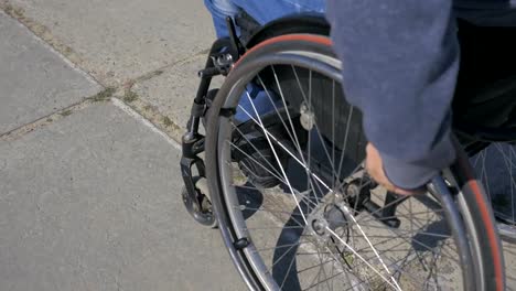 Wheelchair-wheels,-Difficulty-traveling-wheel-chair-on-street,-Disabled-man-in-wheelchair,-movement-people-with-disabilities