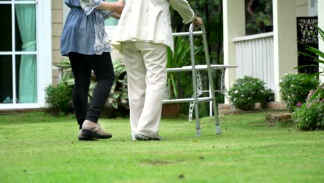 Elderly-woman-exercise-walking-in-backyard-with-daughter