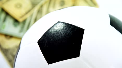 Football-and-dollar-on-white-background-4k