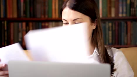 Businesswoman-at-home-working-with-documents-on-laptop.-Home-office-concept.-Remote-freelance-work