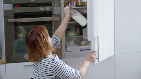 Paraplegic-Woman-Putting-Milk-into-Fridge