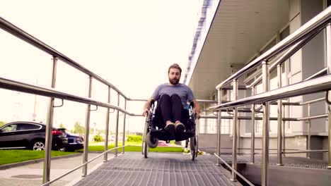 A-disabled-man-in-a-wheelchair-riding-down-the-slope