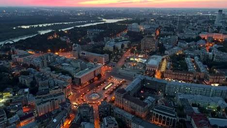 Aerial-view-of-Maidan-Nezalezhnosti-in-Kyiv-(Kiev),-Ukraine-and-the-Dnieper-river-during-sunset-in-the-evening.-The-Independence-Monument-is-seen-in-the-central-part-of-the-image