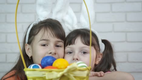 Children-in-bunny-ears-with-a-basket-of-eggs.