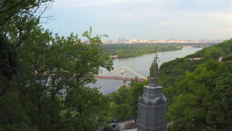 Aerial-view-of-the-Monument-to-Vladimir-the-Great,-the-Pedestrian-Bridge-and-the-Dnieper-River,-Kiev