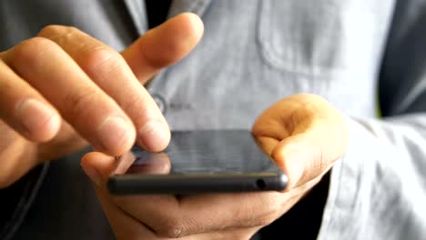 man-in-a-jacket-uses-a-smartphone-touchscreen.