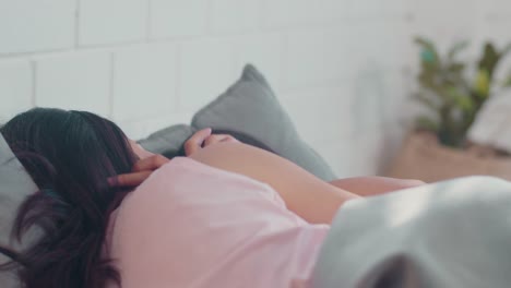 Asian-Lesbian-couple-relax-rest-together-after-wake-up-lying-on-bed-in-bedroom.