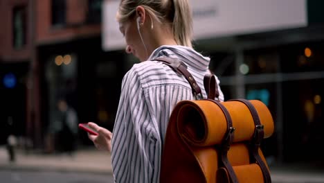 Slow-motion-effect-of-young-Caucasian-tourist-in-electronic-headphones-with-cute-smile