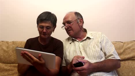 Attractive-adult-woman-and-adult-man-make-a-video-call-with-their-family-on-a-tablet-pc.