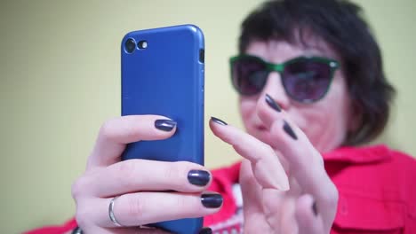 blue-smartphone-in-the-hands-of-a-girl-in-red