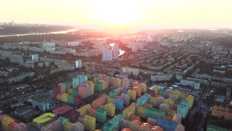 Colorful-buildings-of-a-residential-district,-aerial-shot-from-a-drone-at-sunset-over-Comfort-Town.-Kiev,-Ukraine