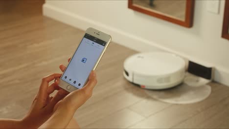 Setting-up-the-robotic-vacuum-cleaner-by-the-app-on-a-phone