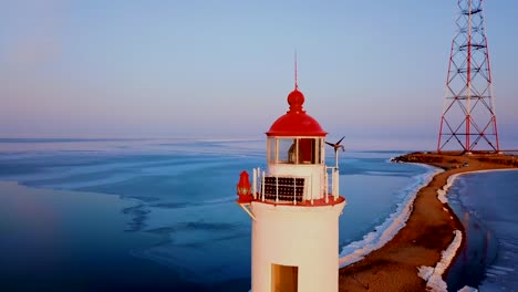 Aerial-winter-view-of-the-Tokarevskiy-lighthouse---one-of-the-oldest-lighthouses-in-the-Far-East,-still-an-important-navigational-structure-and-popular-attractions-of-Vladivostok-city,-Russia.